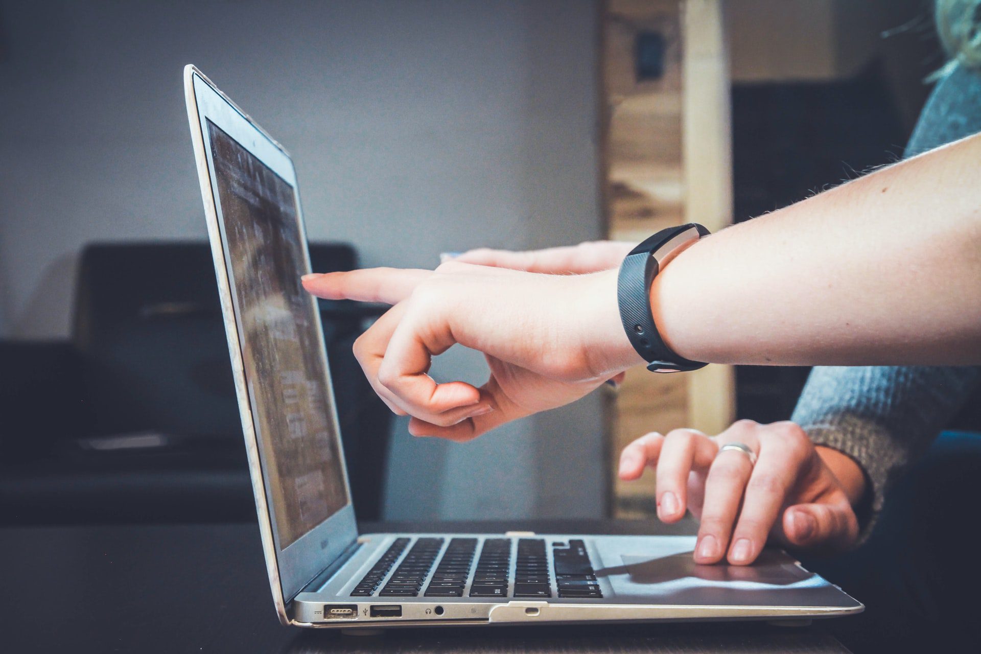 man pointing at laptop